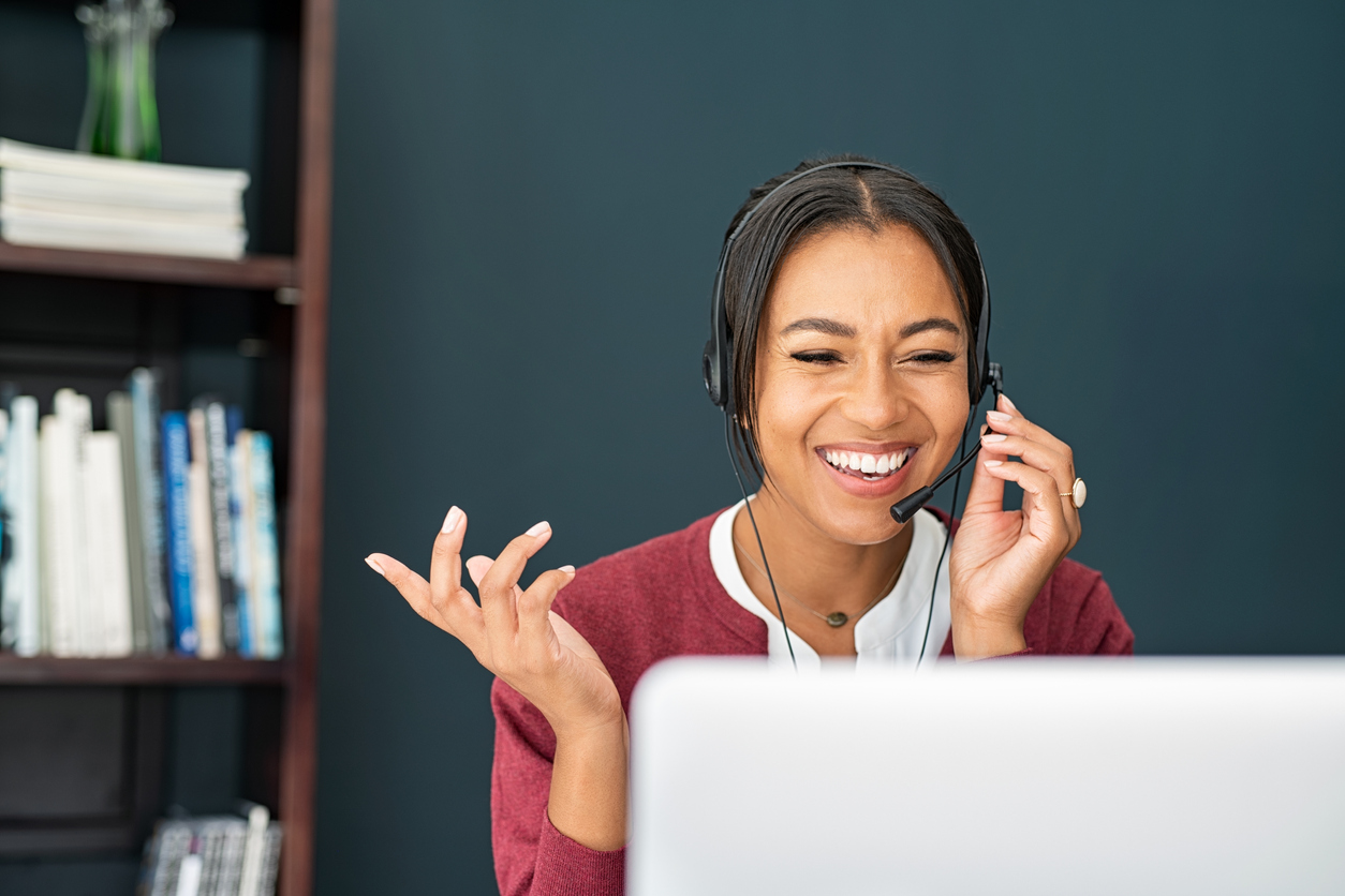 Person with headset looking at computer explaining